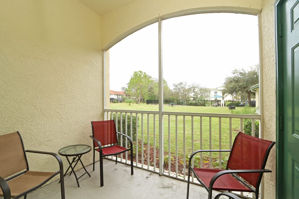 Screened balcony/patio area with view across lawns to Kid's Playground