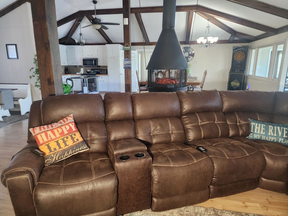Large sectional with two recliners in the great room to enjoy the smart TV.