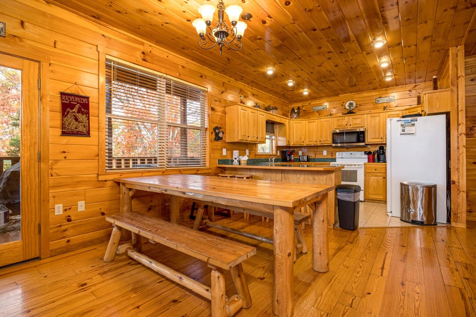 Large log style dining table and bar stools at the kitchen counter
