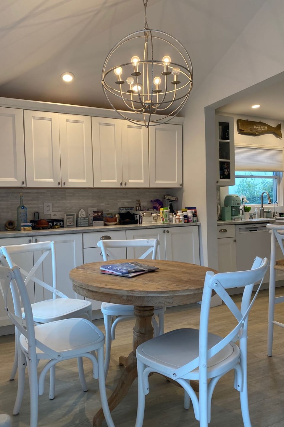 A cozy dining area with  a warm light from a pendant lamp
