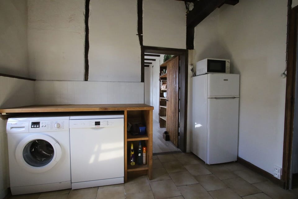 Scullery with dish washer, washing machine, fridge and microwave