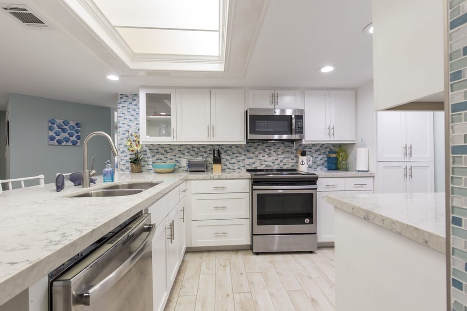 Newly remodeled kitchen with quarts counters, stainless steel appliances