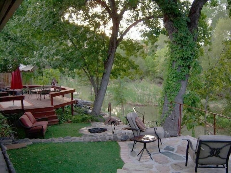Patio, deck, hot tub, firepit lounging space all overlooking  & along the Creek 