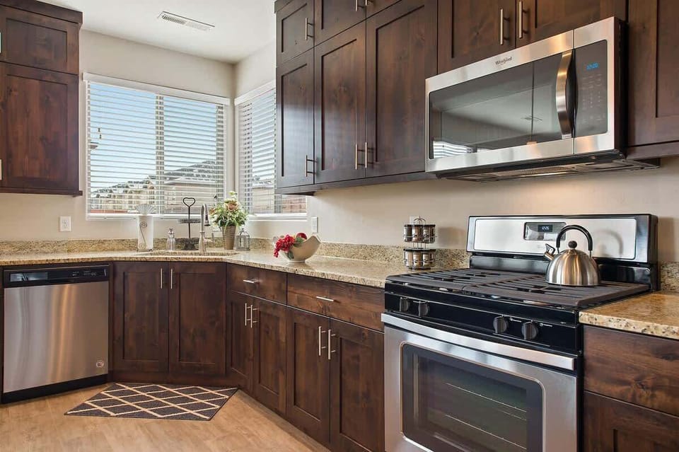 Beautiful custom kitchen with gas range, stainless appliances