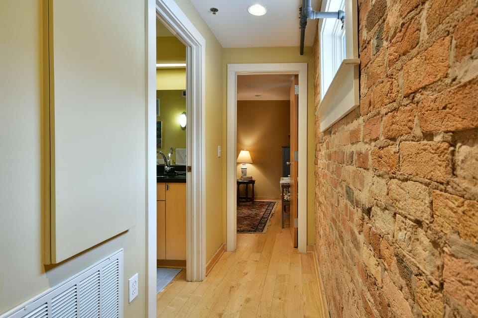 Hallway from  seating area to downstairs queen bedroom and full bath.  