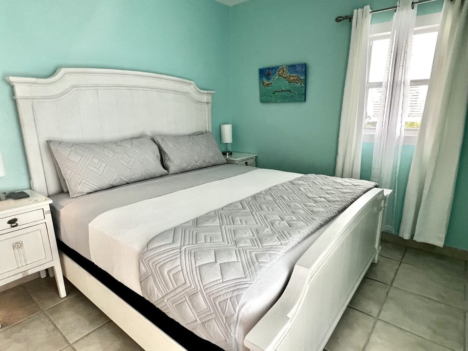 King bedroom with an ensuite bathroom. The corner suite has more windows