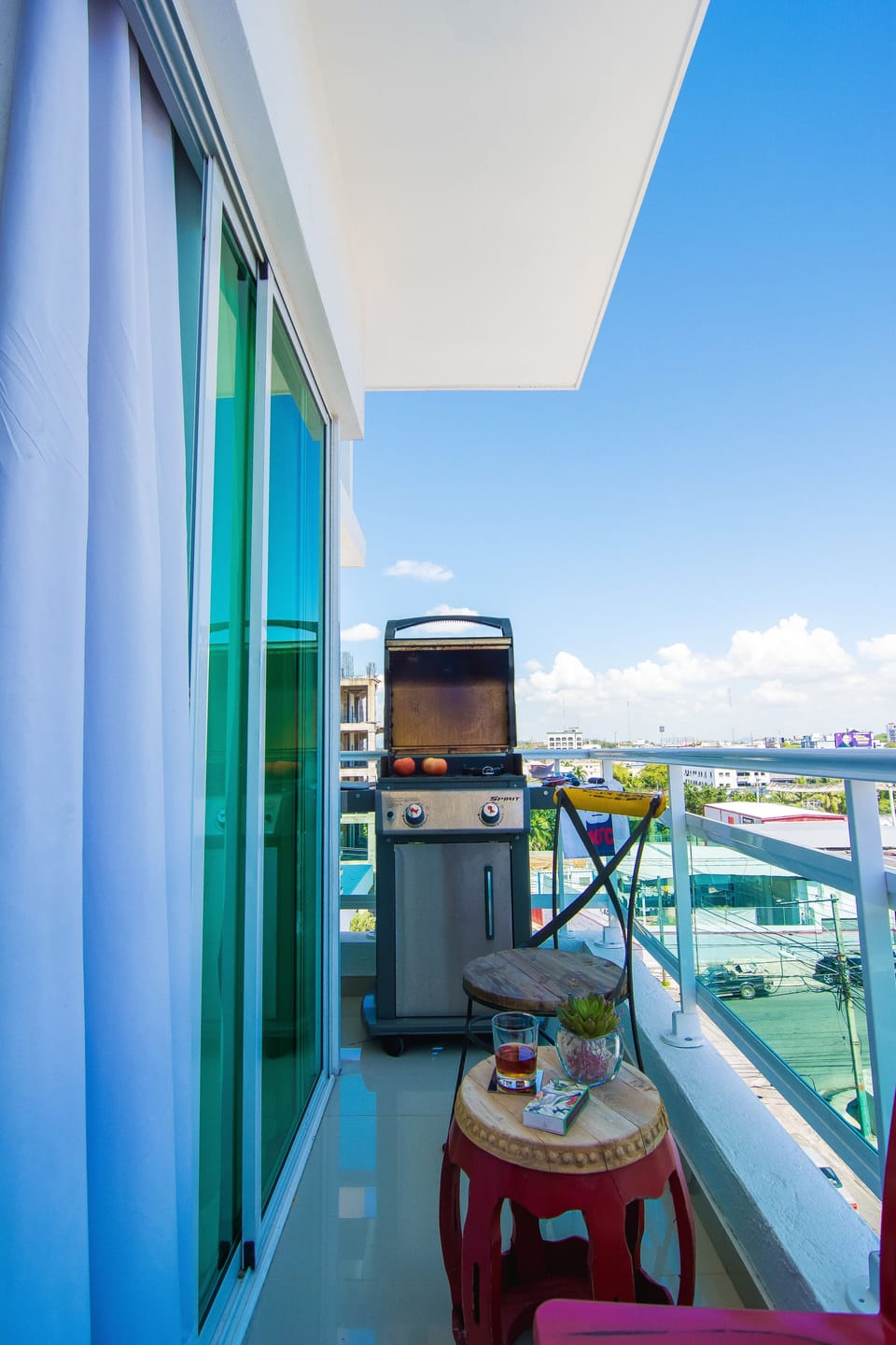 The Private Balcony with beautiful city views comes with a table, seats and barb