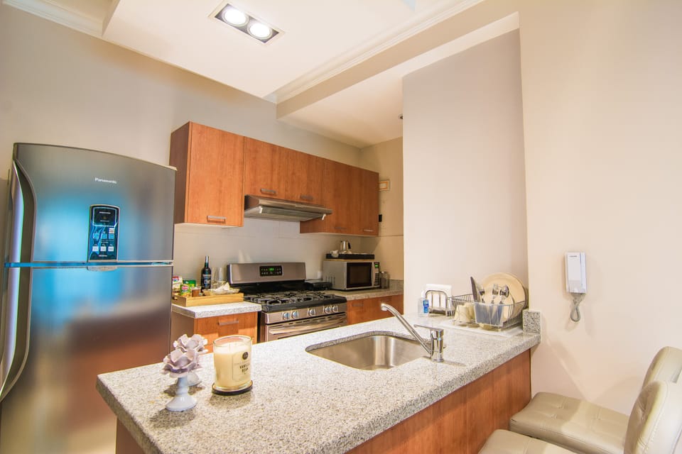 The comfortable living room comes with an Open fully equipped Kitchen, Balcony w