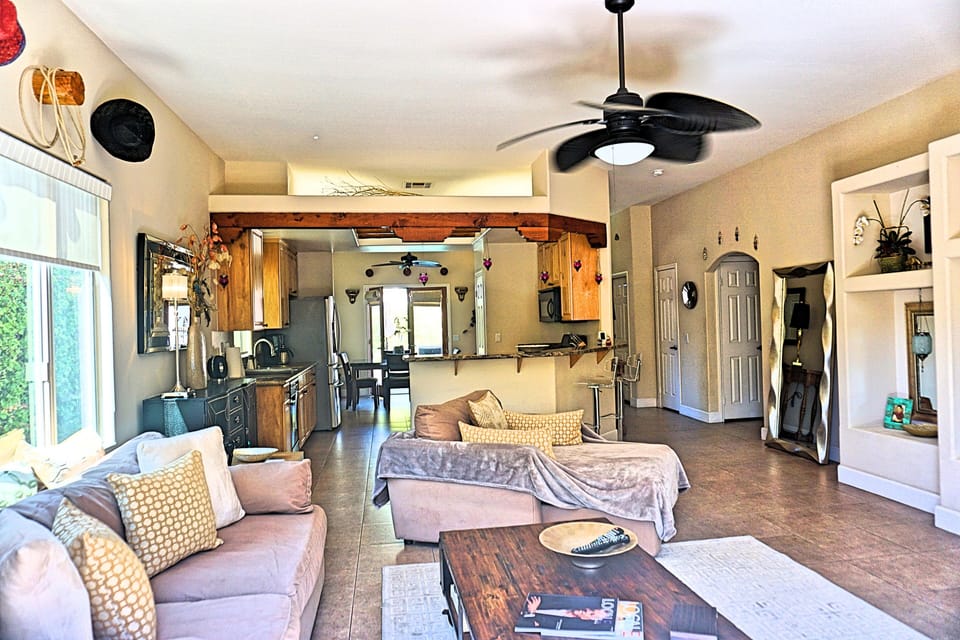 Large bright open Living Room with open kitchen  and patio access.