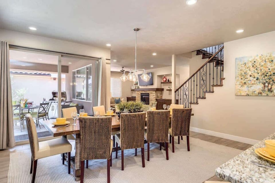 Large dining table and covered back patio with BBQ and table