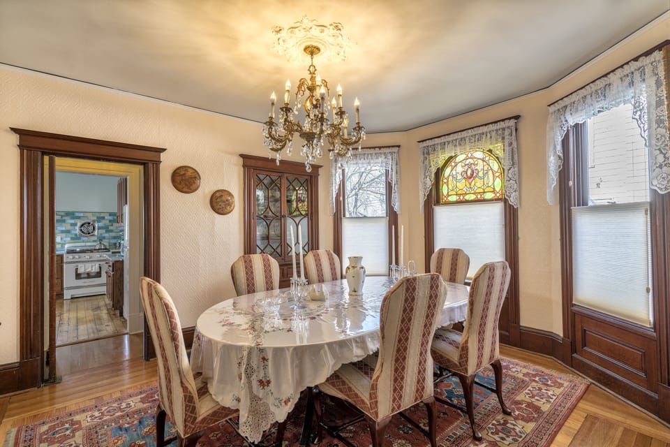 Beautiful dining room with original stained glass windows and lovely chandelier