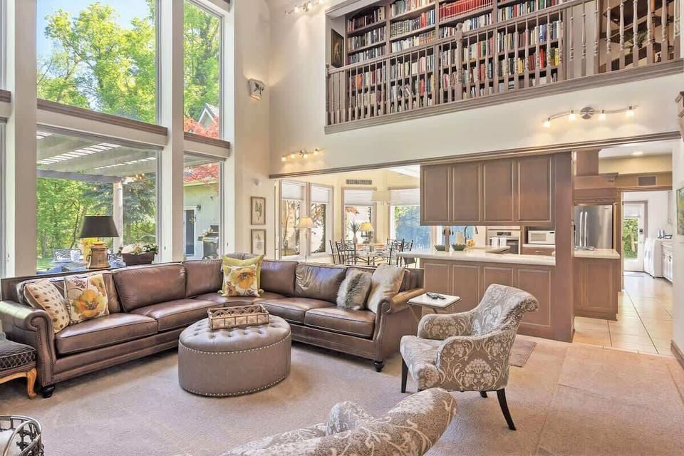 Great room with 30 foot windows open to upper mezzanine library