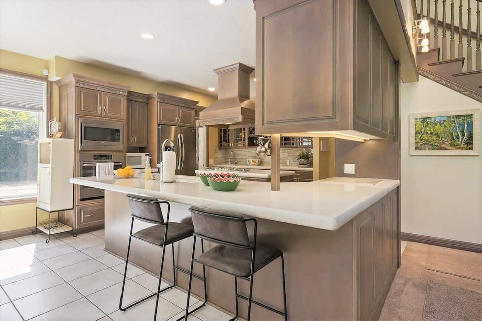 Open concept wrap-around bar with beautiful custom cabinetry
