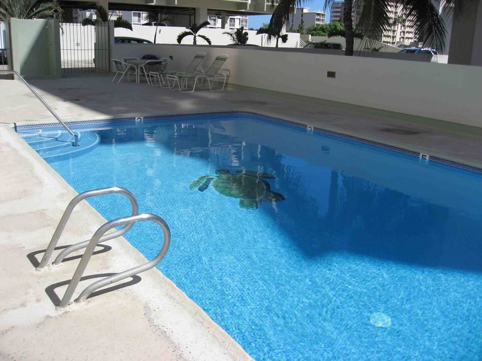 Building has a pool sundeck has tables and chairs