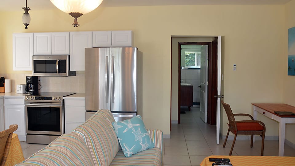 Kitchen. dining, and living areas configured for four, with new appliances