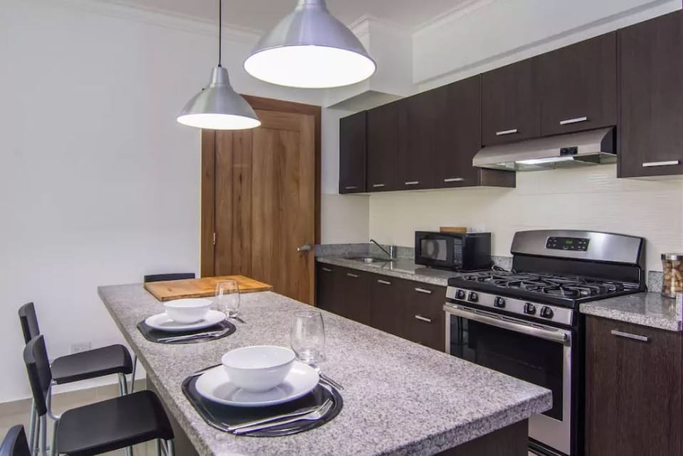 The livingroom comes with an open fully equipped kitchen, balcony, seating area,