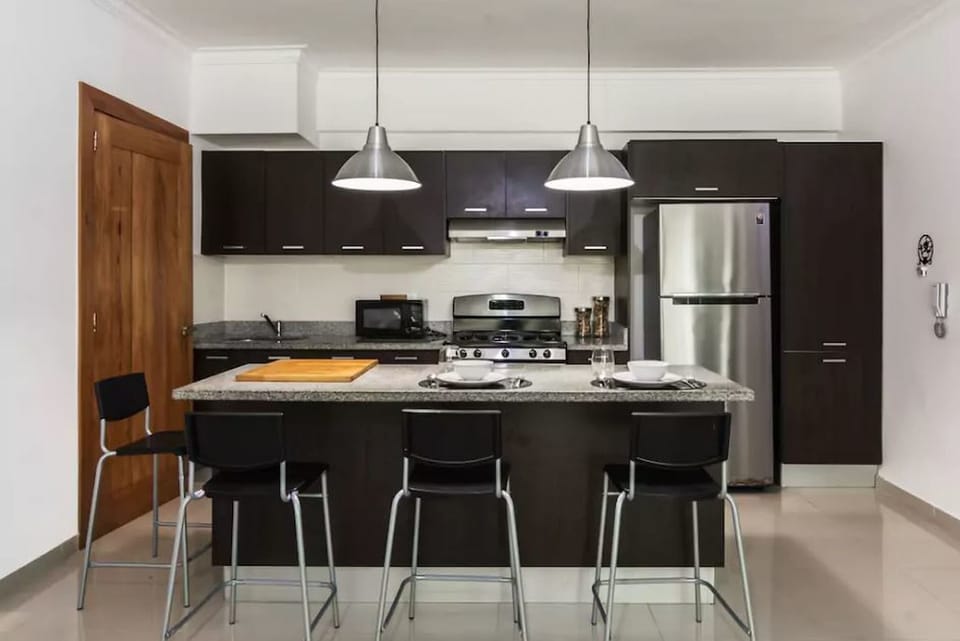 The livingroom comes with an open fully equipped kitchen, balcony, seating area,
