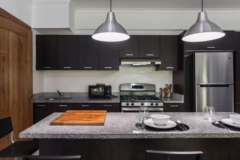The livingroom comes with an open fully equipped kitchen, balcony, seating area,