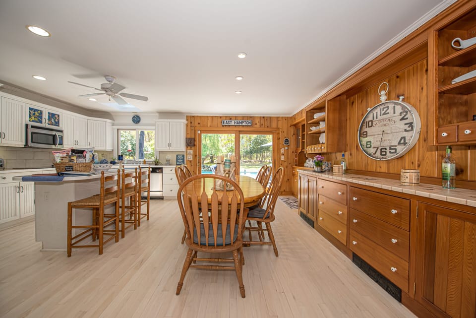 Kitchen and indoor dining in open concept floorplan. Plenty of seats for all.