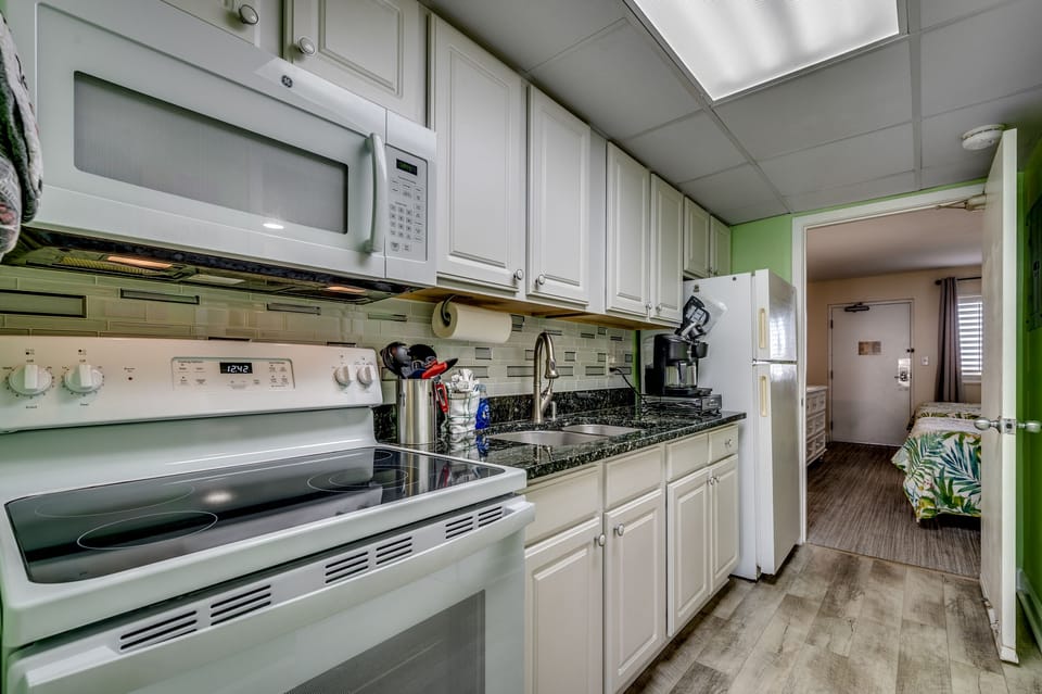 Our kitchenette boasts elegant granite countertops and ample cabinet space.