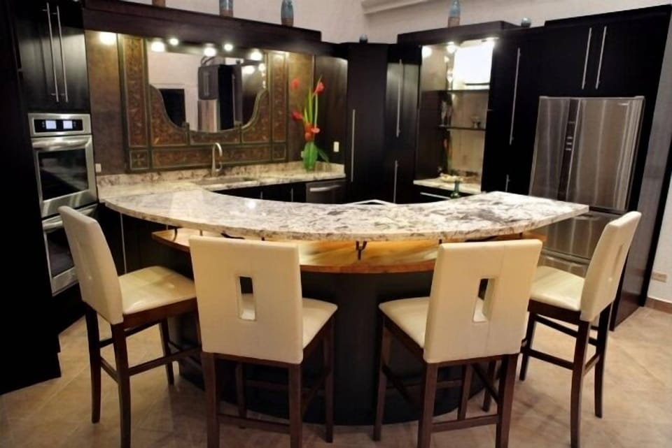 Inviting wood finishes and marble tops in kitchen