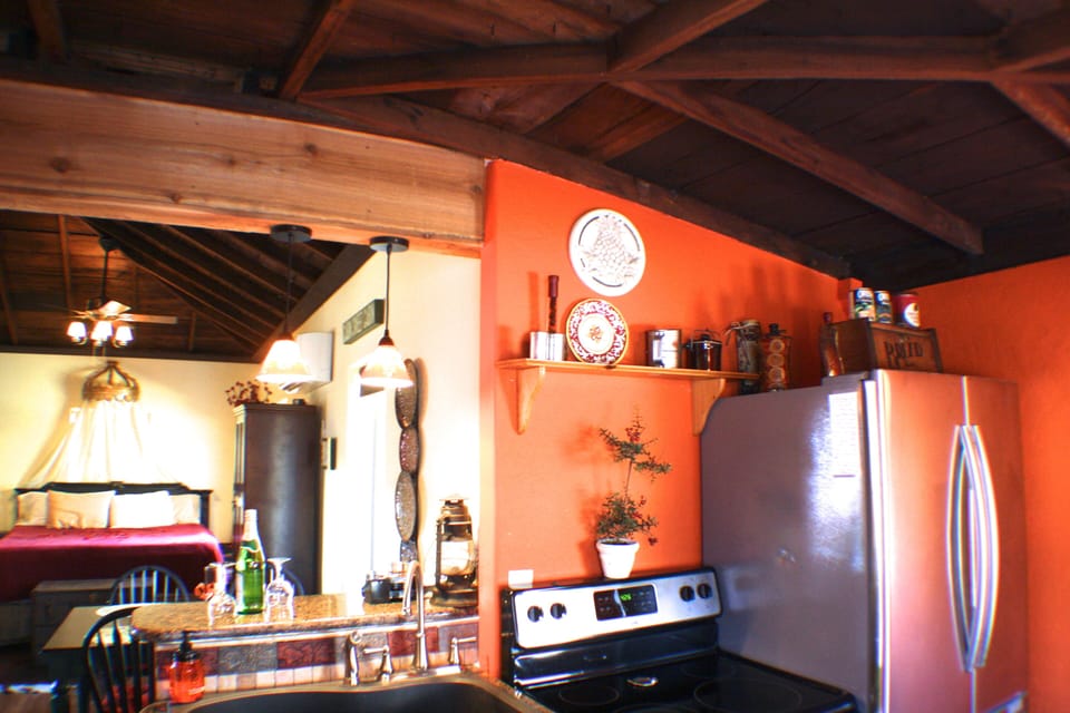Stainless steel kitchen with granite bar - looking to bedroom