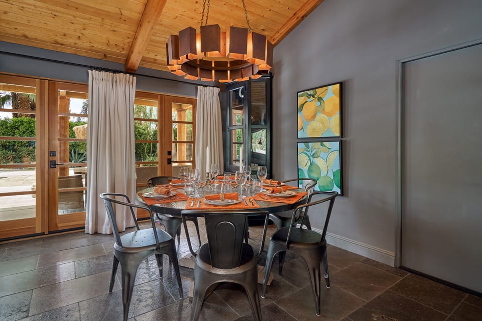Dining with backyard view through French doors leading to pool oasis.