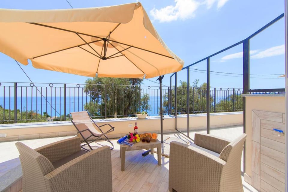 Outdoor terrace with chairs and sun ombrella
