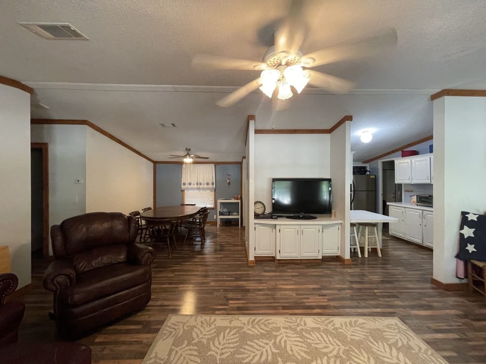 Living room with Smart TV, couches, recliners, Full River View....!
