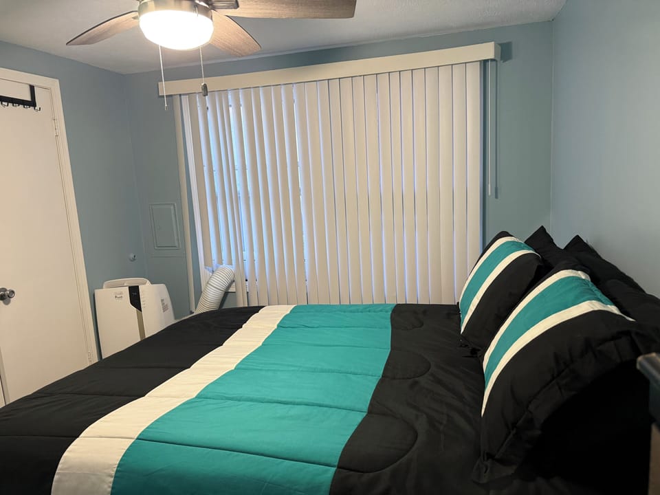 2nd bedroom with a queen size bed and independently controlled A/C unit .