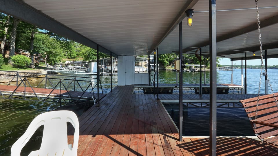 View of dock, dock storage shed, and dock boat slips from the dock swim deck.