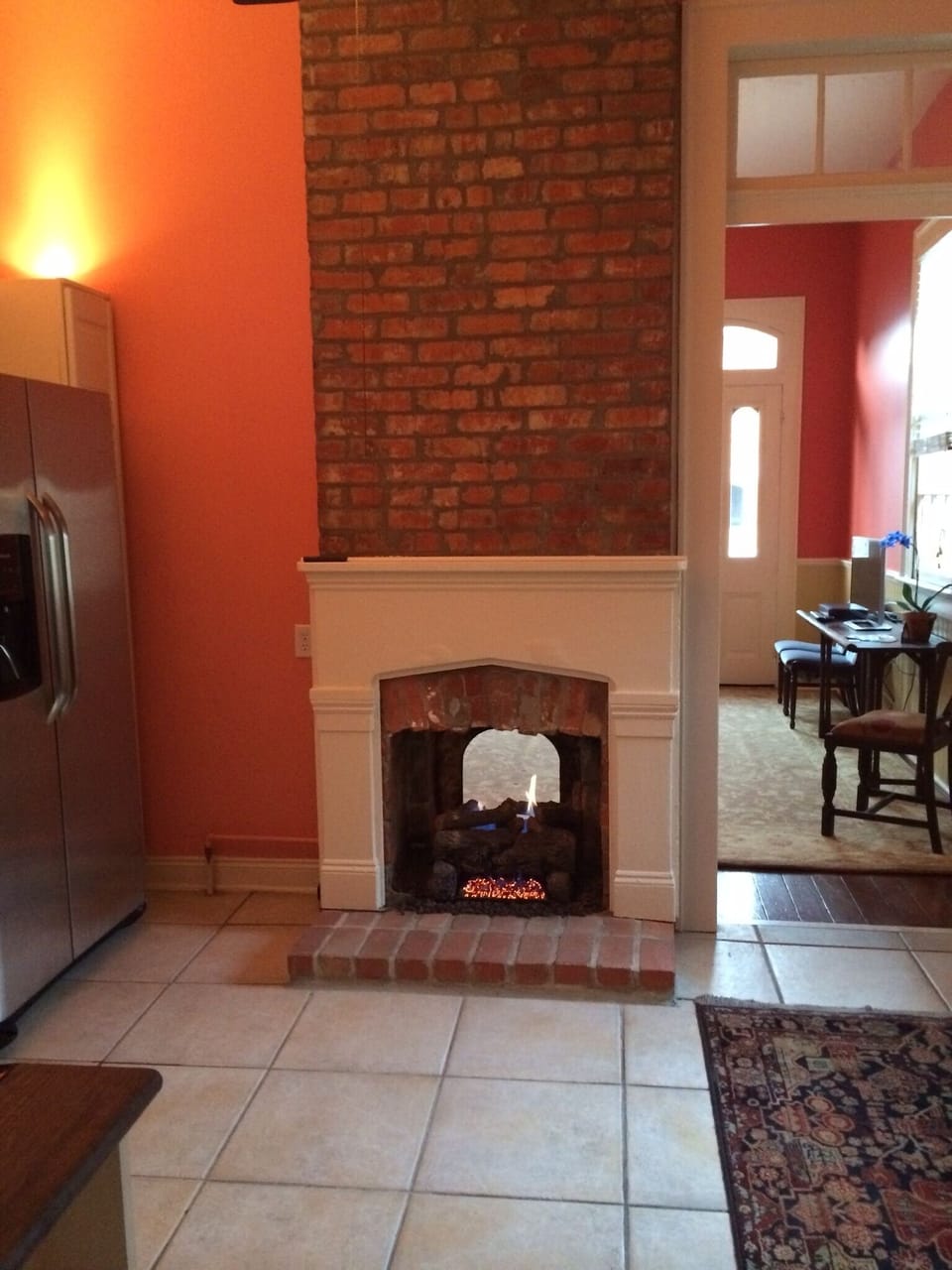 The fireplace opens into the living room and the kitchen. 