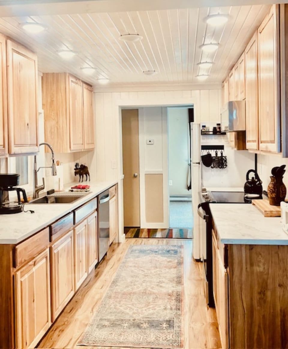 Renovated kitchen with new appliances and cabinets.