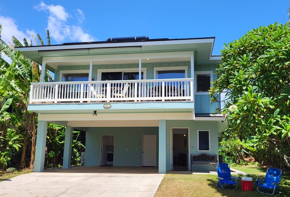 Casual vacation home by the beach with covered parking at your front door.