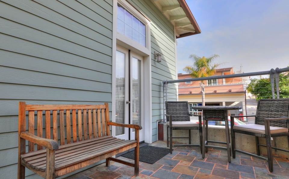 Private patio area with bistro table and bench seating. Webber Charcoal BBQ.