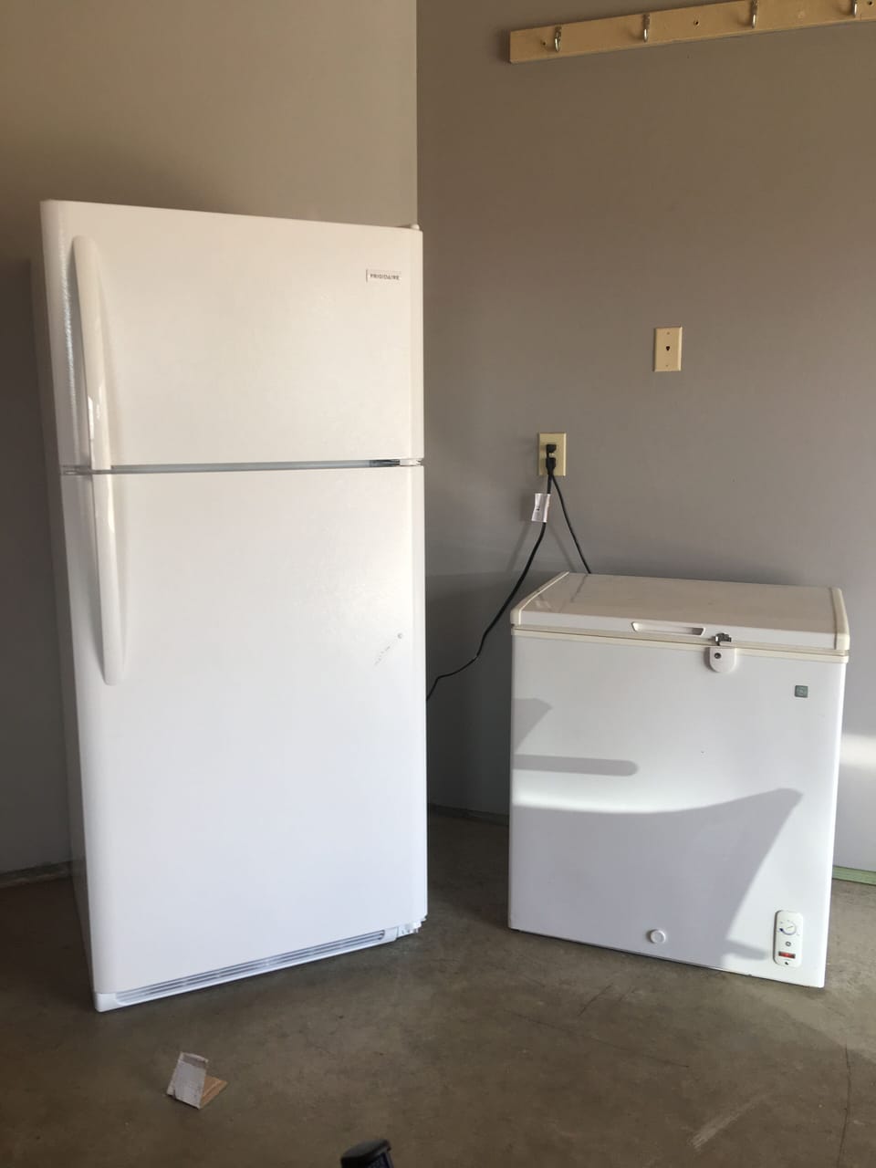 Brand new refrigerator and small freezer in garage.