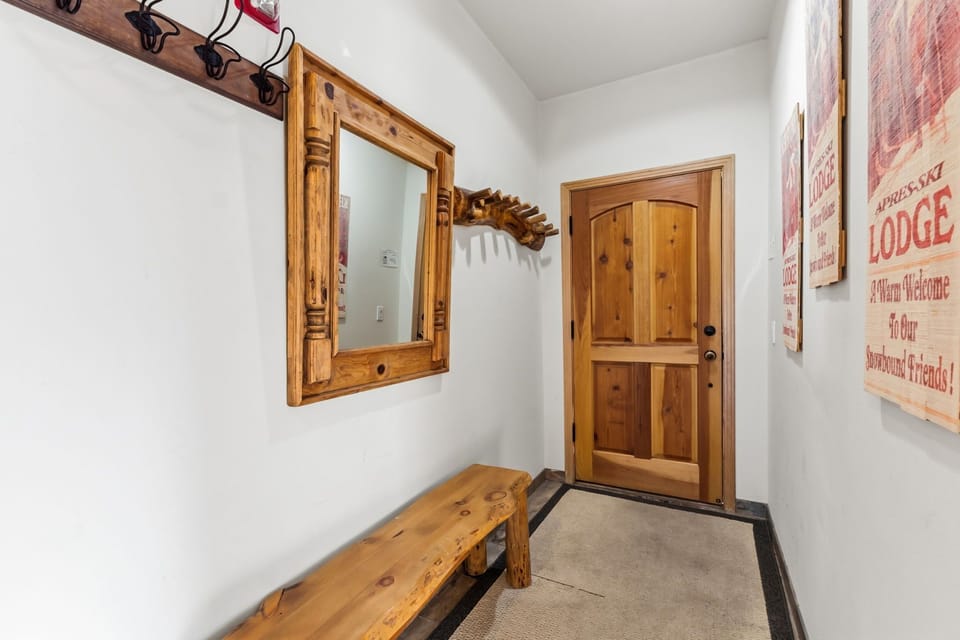 Step into your charming entryway where rustic wood details and cozy lodge touches create the perfect mountain retreat welcome.