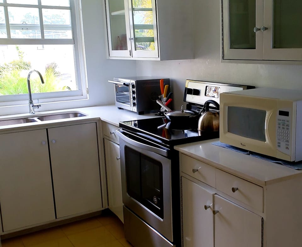 Brand new Whirlpool electric stove and KitchenAid toaster oven with pizza tray.
