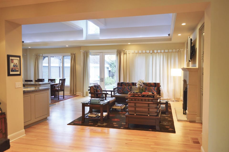 Well lit living room area looking out to the backyard.