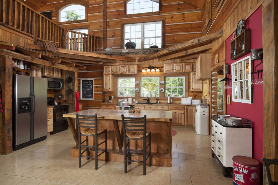 Spacious Vaulted Ceiling Kitchen with an Old Bus Stop and Stainless Appliances.