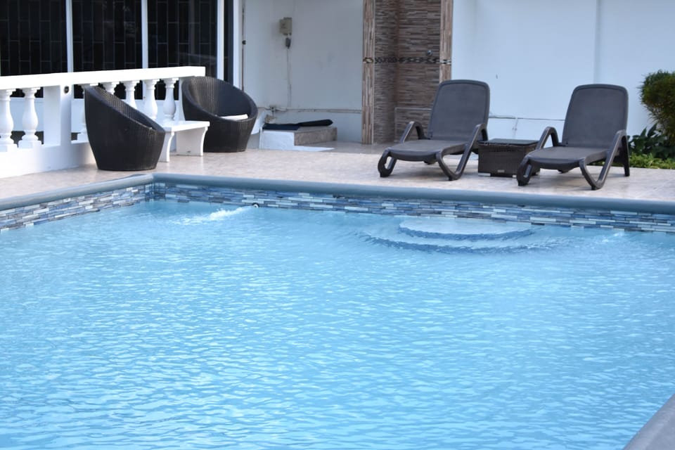 Swimming pool with 4 loungers two tables two chairs with outside shower 