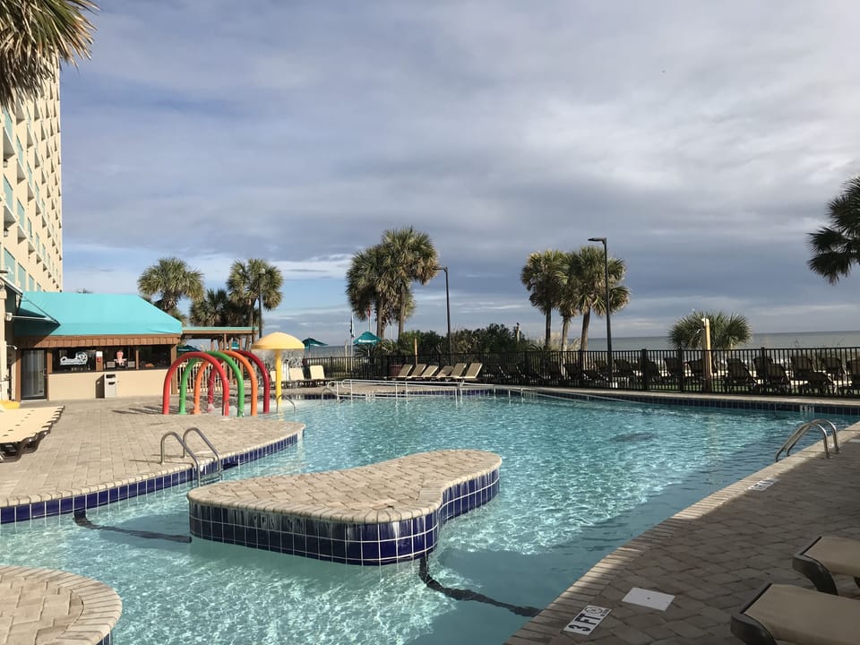 Newly renovated pool and lazy river area overlooking the ocean