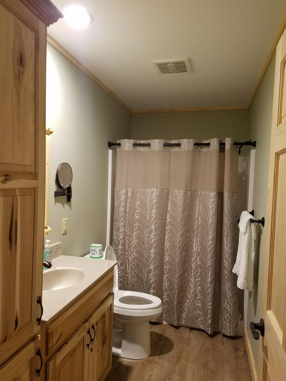bathroom has walk in shower, vanity, toilet, towels