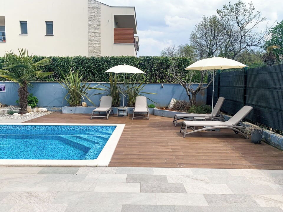 Swimming Pool, Outdoor Furniture, Flooring, Floor, Resort, Umbrella, Furniture, Residential Area, Sunlounger, Shade