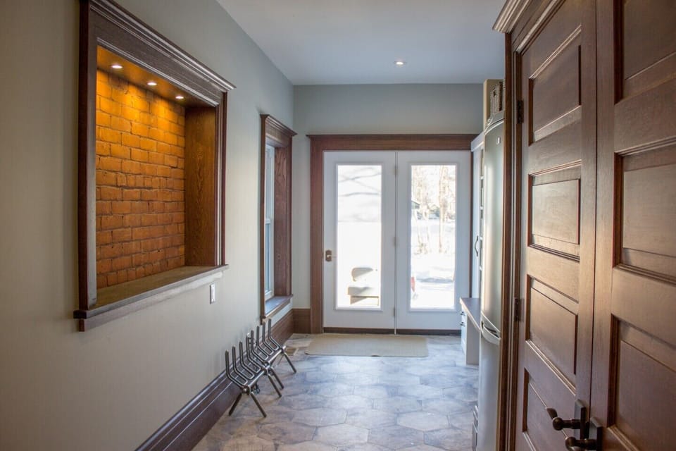 New mud room with heated boot rack, storage and second fridge.