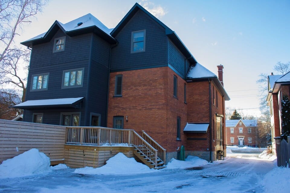 Back of house in winter, exterior access to mud room for equipment storage.