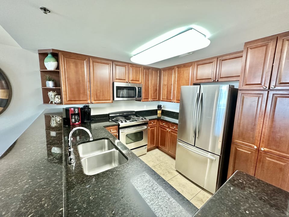 Large kitchen with lots of storage stocked with all cooking essentials. 