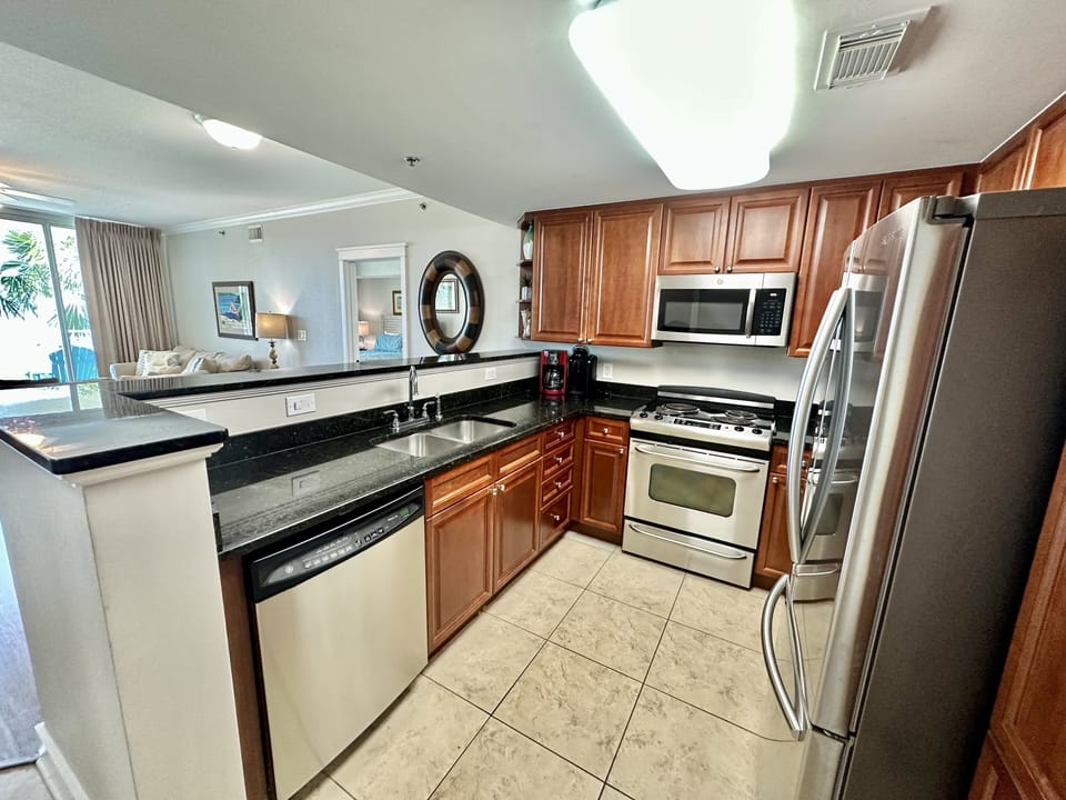 Large kitchen with lots of storage stocked with all cooking essentials. 