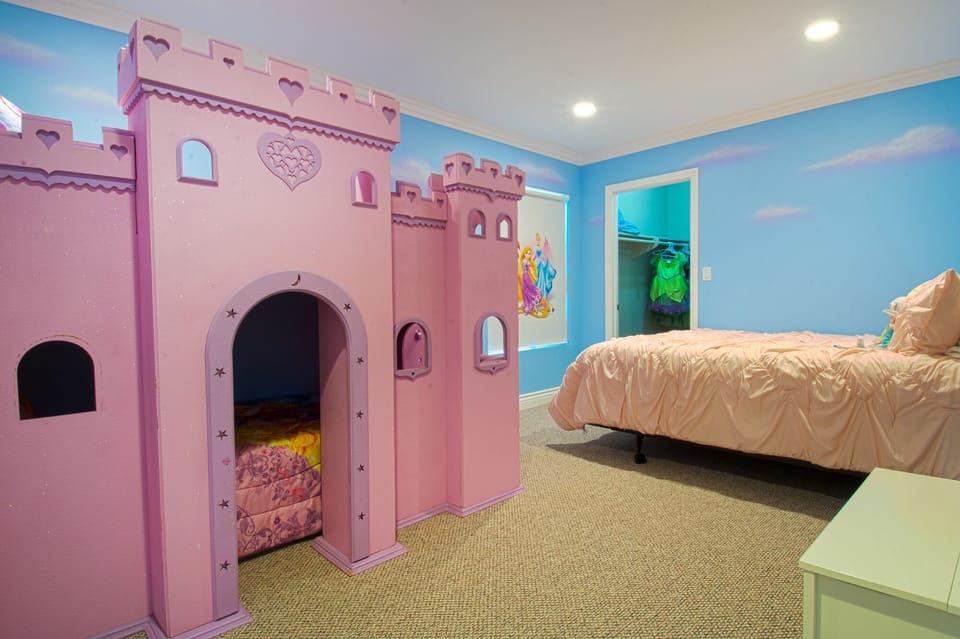 - Princess bedroom with pink castle bed and fairytale décor theme   - Bright colorful design makes it magical for children’s vacations   - Family-friendly space perfect for imaginative play and rest