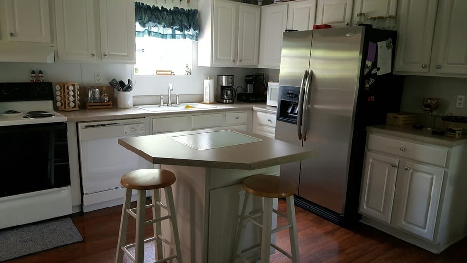 fully stocked kitchen with full size range, fridge, dishwasher and microwave